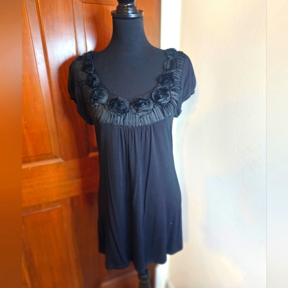 Black tunic top with floral neckline trim